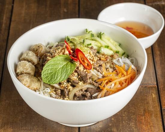 Bún chả and spring rolls vermicelli salad bowl
