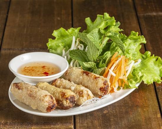 Crispy fried spring rolls served with fresh herbs and dipping sauce